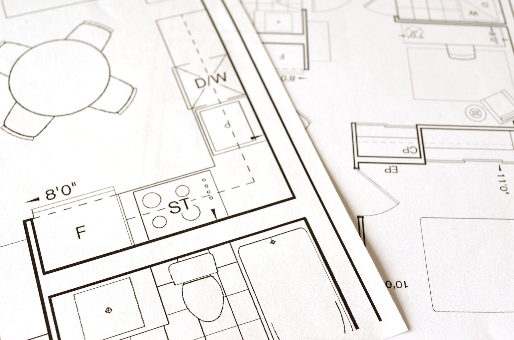 Architectural floor plans laid out on a table